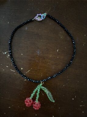 Susan Alexandra Black Beaded Necklace with Red Cherry and Green Leaf Charm